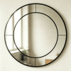Black round wall mirror with segmented mirrored outer ring and concentric metal frame Round Mirror with Mirrored Frame